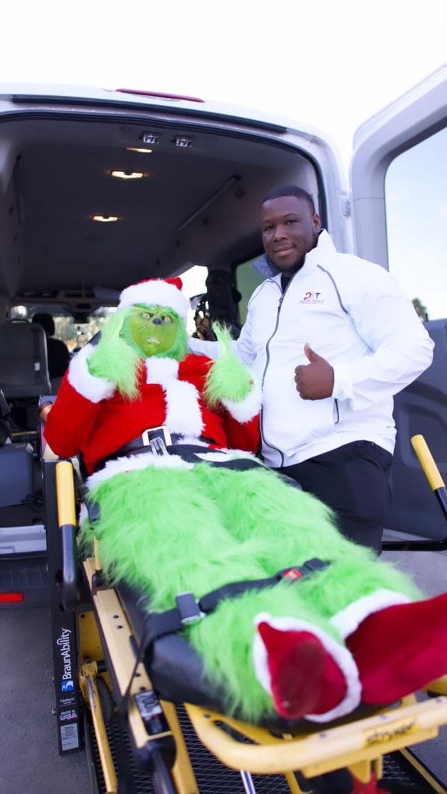 Photo of Ken Moreland, owner of Diamonds Medical Transportation, smiling next to his vehicle